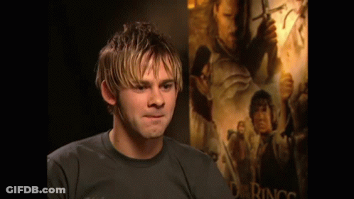 Man Standing In Front Of Big Poster GIF