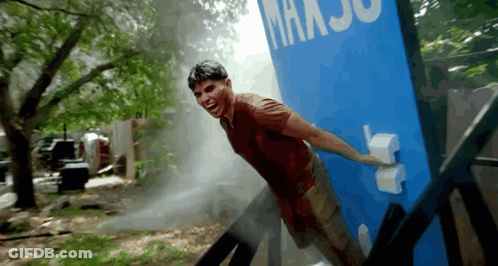 Man Standing In Front Of Blue Wall Saying Maxjo GIF