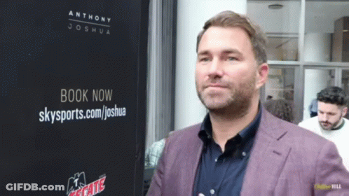 Man Standing In Front Of Book Now Sign GIF