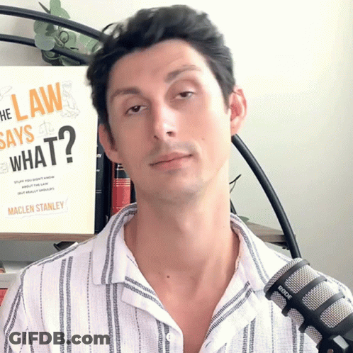 Man Standing In Front Of Book Saying What GIF