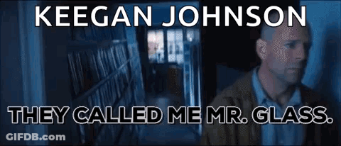 Man Standing In Front Of Bookshelf Saying Mr. Glass GIF