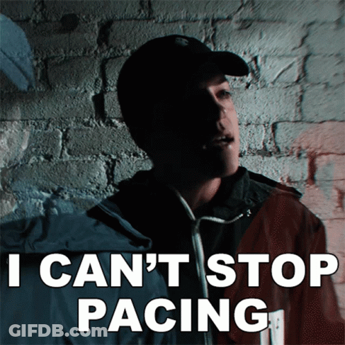 Man Standing In Front Of Brick Wall Saying I Can't Stop Pacing GIF