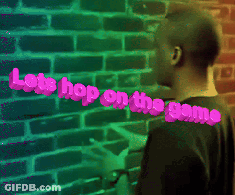 Man Standing In Front Of Brick Wall Saying Let's Hop On The Game GIF