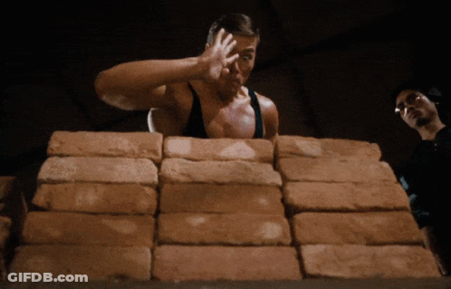Man Standing In Front Of Bricks GIF