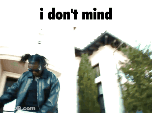Man Standing In Front Of Building Saying I Don't Mind GIF