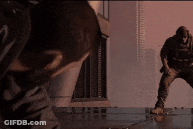 Man Standing In Front Of Building With Another Man Looking On GIF