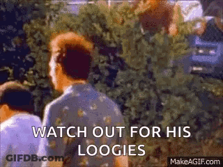 Man Standing In Front Of Bush Saying Watch Out For His Loogies GIF