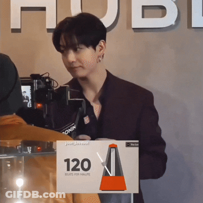 Man Standing In Front Of Camera With Sign Saying 120 Beats Per Minute GIF