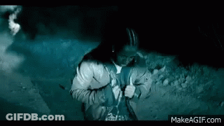Man Standing In Front Of Car With Lights On GIF