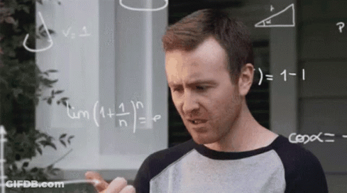 Man Standing In Front Of Chalkboard With Equations GIF