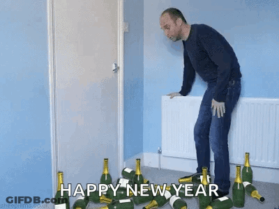 Man Standing In Front Of Champagne Bottles GIF