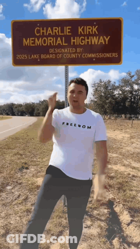 Man Standing In Front Of Charlie Kirk Memorial Highway GIF