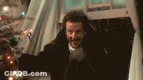 Man Standing In Front Of Christmas Tree GIF