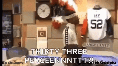 Man Standing In Front Of Clock Next To Jersey Saying 52 GIF