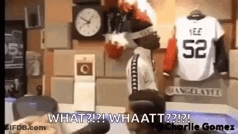 Man Standing In Front Of Clock Next To Jersey Saying What GIF