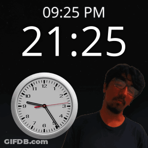 Man Standing In Front Of Clock Saying 21:25 GIF