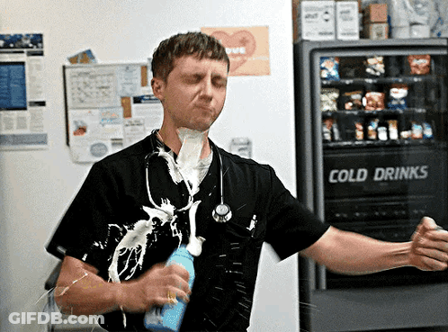 Man Standing In Front Of Cold Drinks Machine GIF