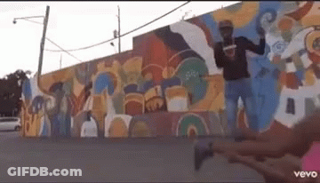 Man Standing In Front Of Colorful Wall GIF
