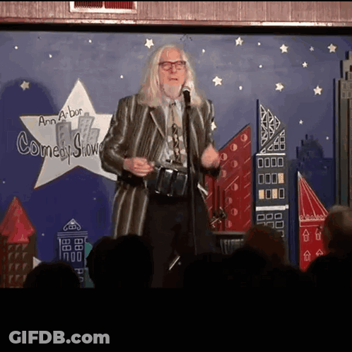 Man Standing In Front Of Comedy Show Sign GIF