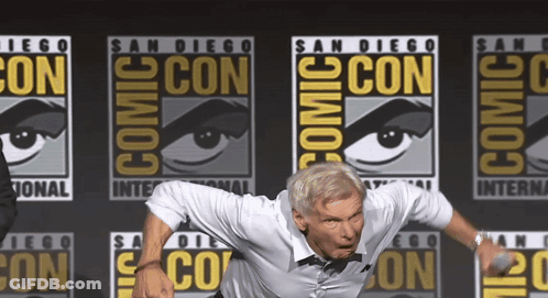 Man Standing In Front Of Comic Con Logo GIF