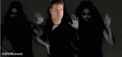 Man Standing In Front Of Dancing Women Black And White Photo GIF