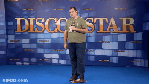 Man Standing In Front Of Disco Star Banner GIF