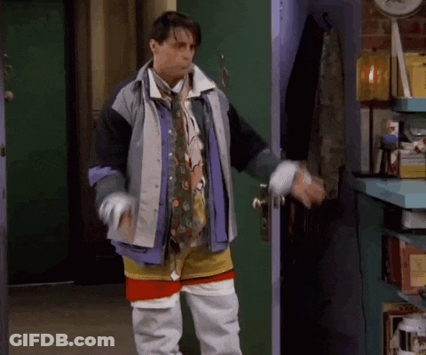 Man Standing In Front Of Door Wearing Jacket And Tie GIF