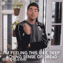 Man Standing In Front Of Door With Arms Crossed Says I'm Feeling This GIF