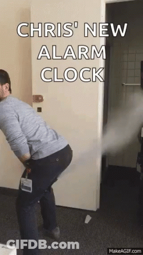 Man Standing In Front Of Door With Chris New Alarm Clock GIF