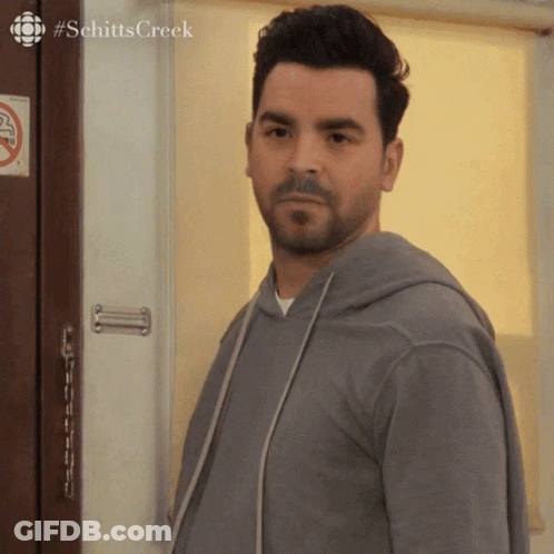 Man Standing In Front Of Door With Schitts Creek GIF
