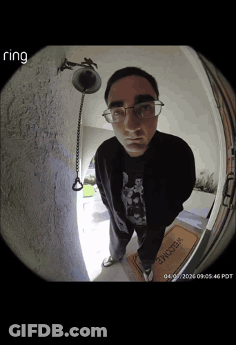 Man Standing In Front Of Door With Welcome Mat GIF