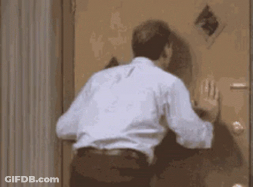 Man Standing In Front Of Door GIF