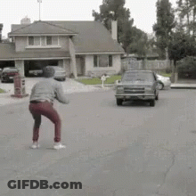Man Standing In Front Of Driving Car GIF
