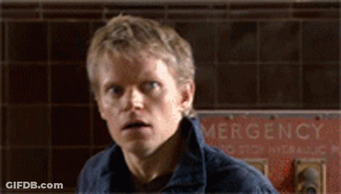 Man Standing In Front Of Emergency Sign GIF