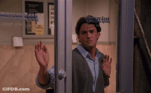 Man Standing In Front Of Emerson Bank Window GIF