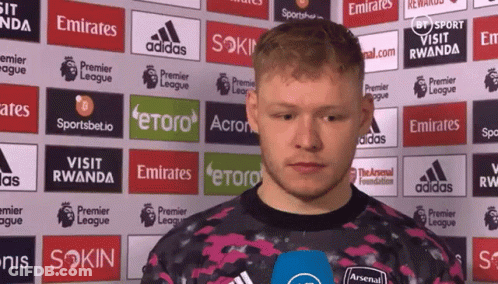 Man Standing In Front Of Emirates Ads GIF
