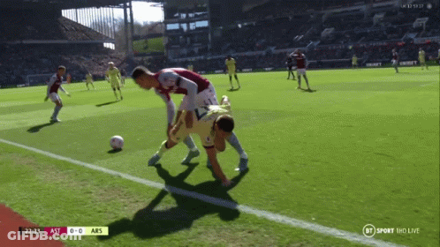 Man Standing In Front Of Emirates TCL And Betway Ads GIF