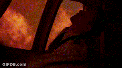 Man Standing In Front Of Fire In Dark Room GIF