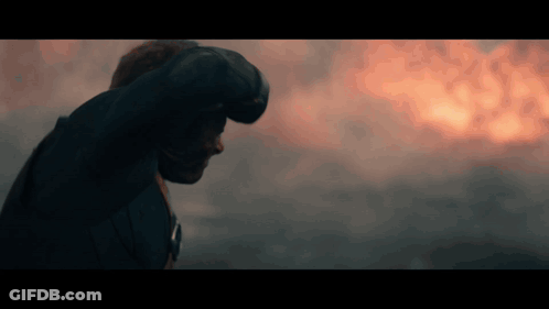 Man Standing In Front Of Fire With Fist GIF