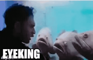 Man Standing In Front Of Fish Saying Eyeking GIF