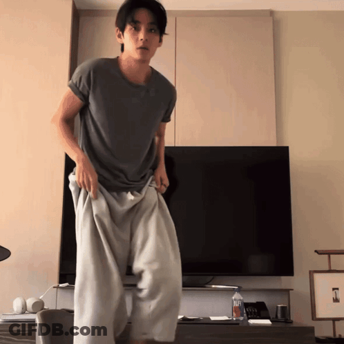 Man Standing In Front Of Flat Screen TV With Aquafina Water GIF