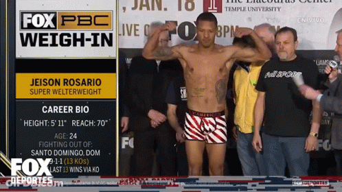 Man Standing In Front Of Fox PBC Sign GIF
