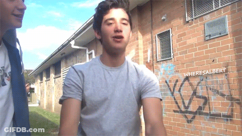 Man Standing In Front Of Graffiti Wall GIF