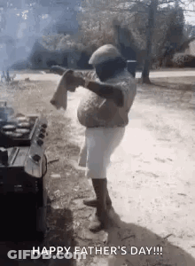 Man Standing In Front Of Grill With Towel On Shoulder GIF