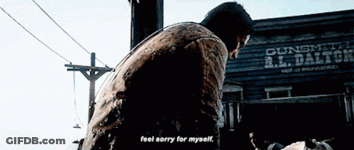 Man Standing In Front Of Gunsmith R.L. Dalton Building GIF