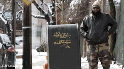 Man Standing In Front Of House Sign GIF