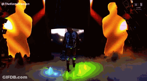 Man Standing In Front Of Kom Dreesen Screen GIF