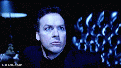 Man Standing In Front Of Large Batman Logo GIF