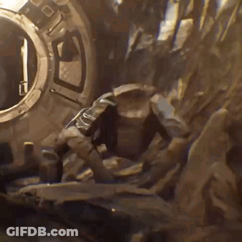 Man Standing In Front Of Large Rock GIF
