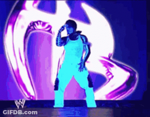 Man Standing In Front Of Large Screen With W Logo GIF